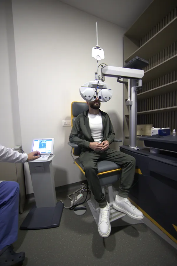 Patient eye exam at the phoropter with a doctor at Universal Eye Hospital, Tirana